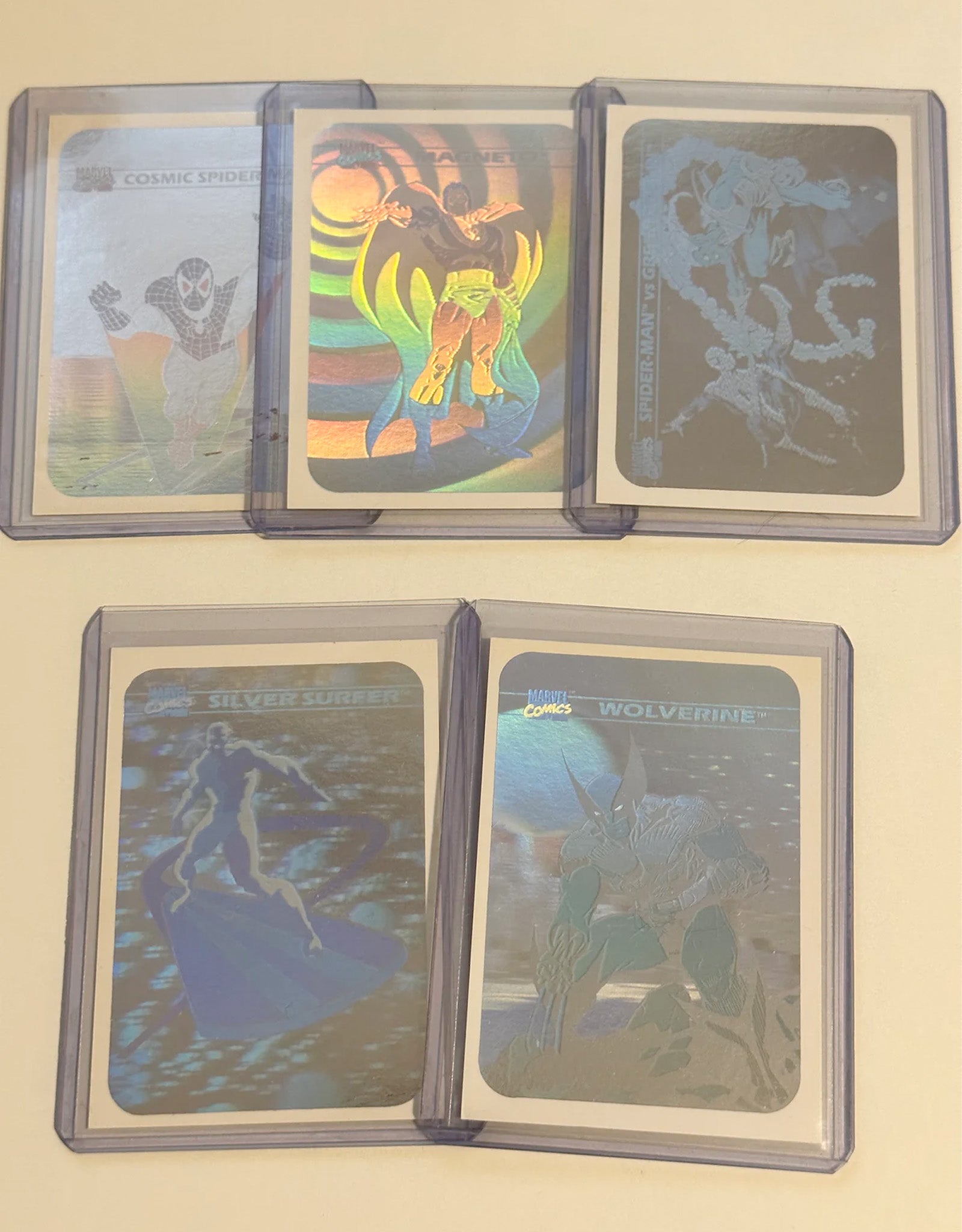 Five Marvel Superhero trading cards displayed on a beige background