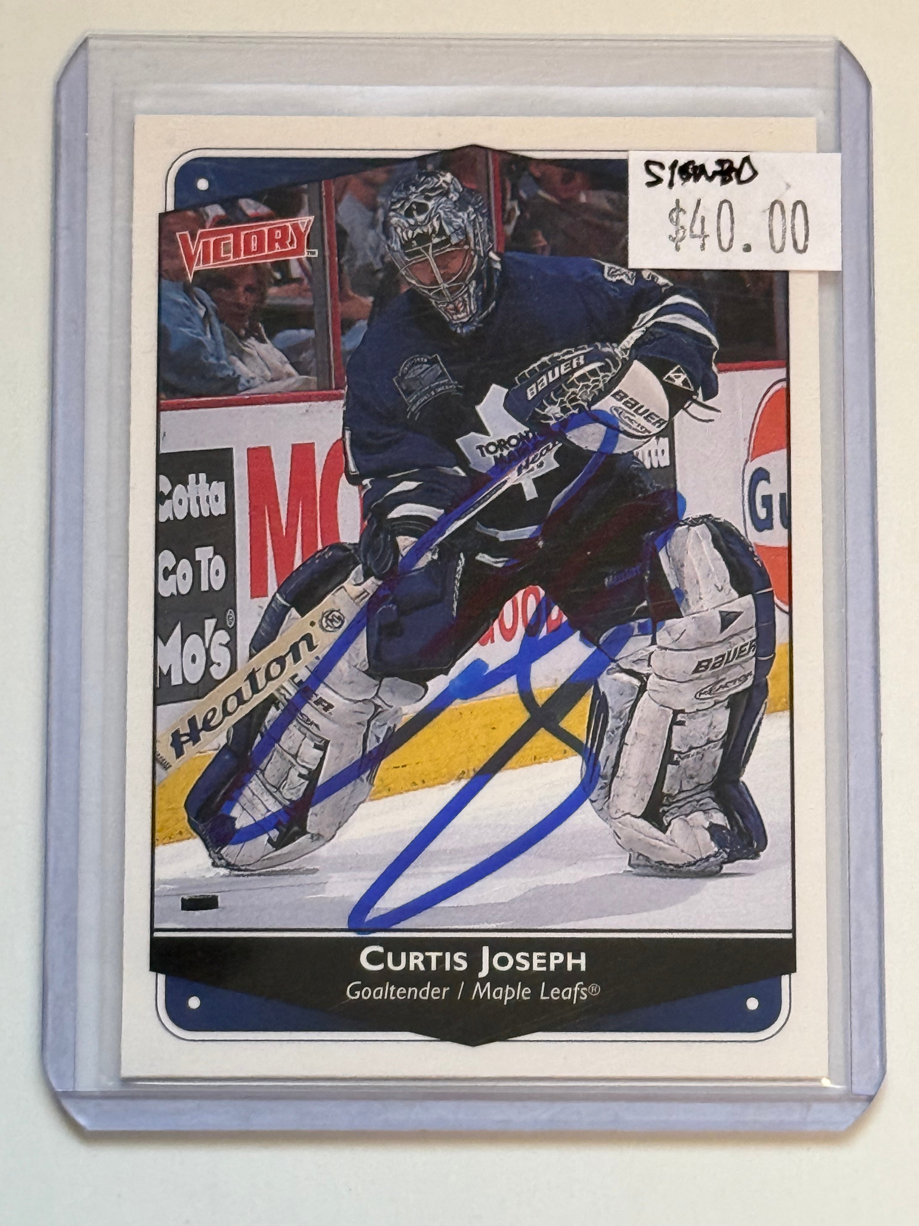 Curtis Joseph leafs autograph card with COA