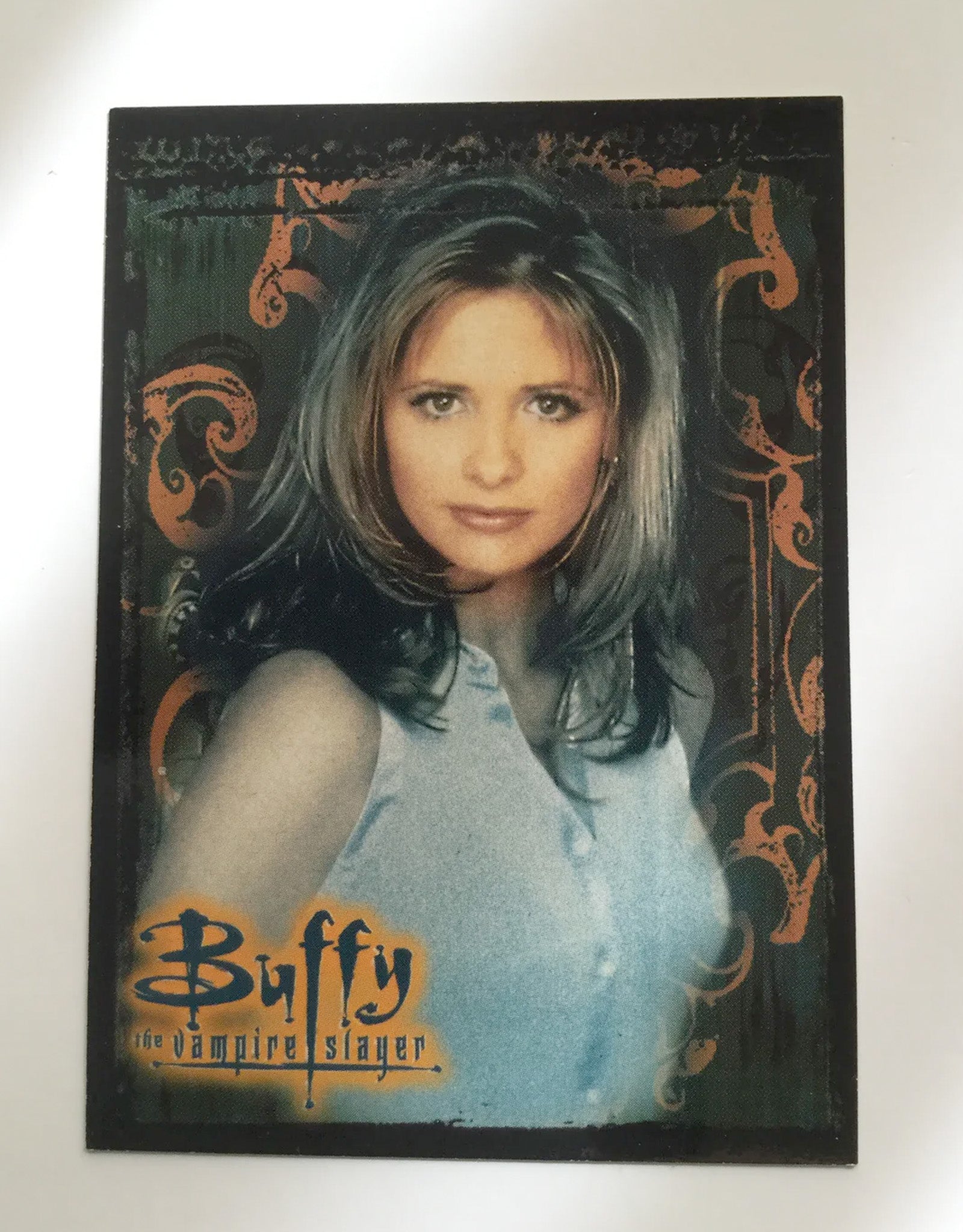 Trading card featuring a character from 'Buffy the Vampire Slayer' with decorative border on a white background