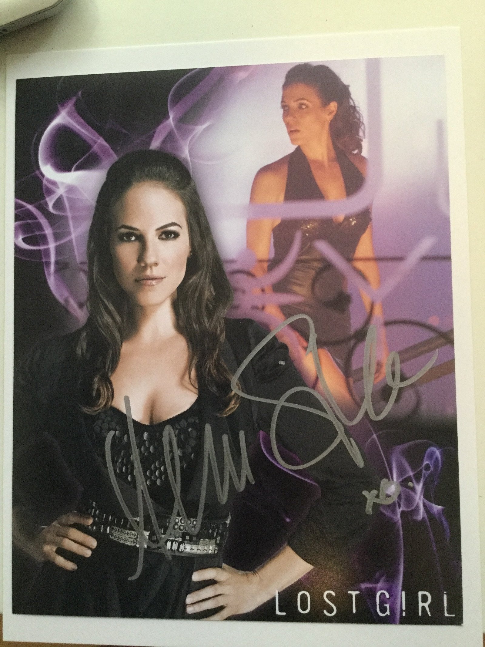 Signed 8x10 photo of the actress from the TV series Lost Girl, with a purple tint and signature.